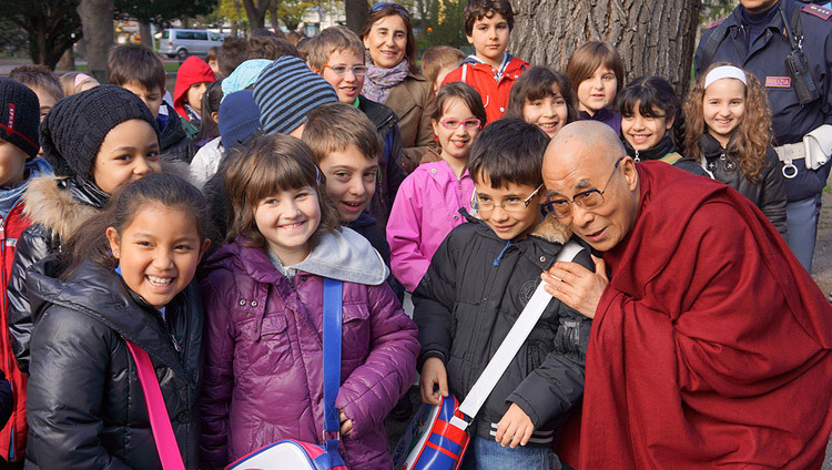 His Holiness the Dalai Lama stops to talk to a group of school children on his way to the Provincial Offices in Bolzano, South Tyrol, Italy, on April 10, 2013.(Photo by Jeremy Russell/OHHDL)