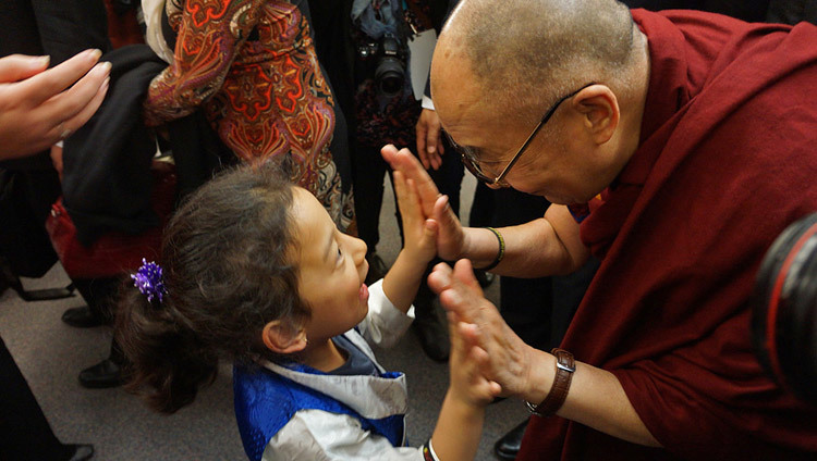 His Holiness the Dalai Lama greeting a young girl during his visit to Vancouver, BC, Canada on October 22, 2014. (Photo by Jeremy Russell/OHHDL)