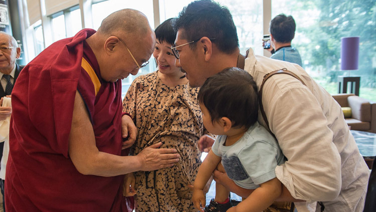His Holiness the Dalai Lama blessing an expectant mother as he leaves his hotel in Narita on his way to Osaka, Japan on May 9, 2016. (Photo by Tenzin Choejor/OHHDL)